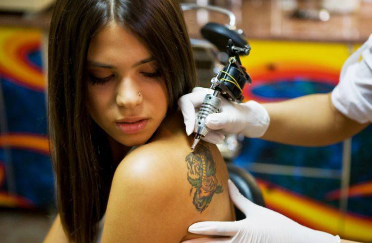 Girl getting tattoo