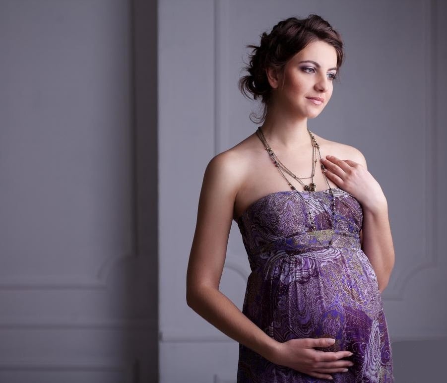 woman-holds-pregnant-stomach.jpg
