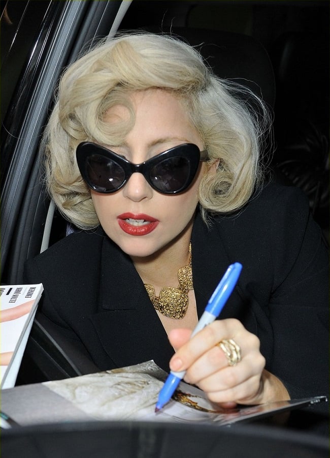 Lady Gaga, wearing cat eye sunglasses and a revealing top, channels her inner Marilyn Monroe while leaving her hotel