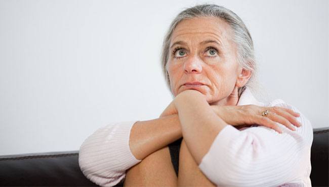 OLDER WOMAN LOOKING PENSIVE