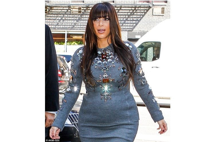 Kim Kardashian showing her maternity curves in bejewelled dress