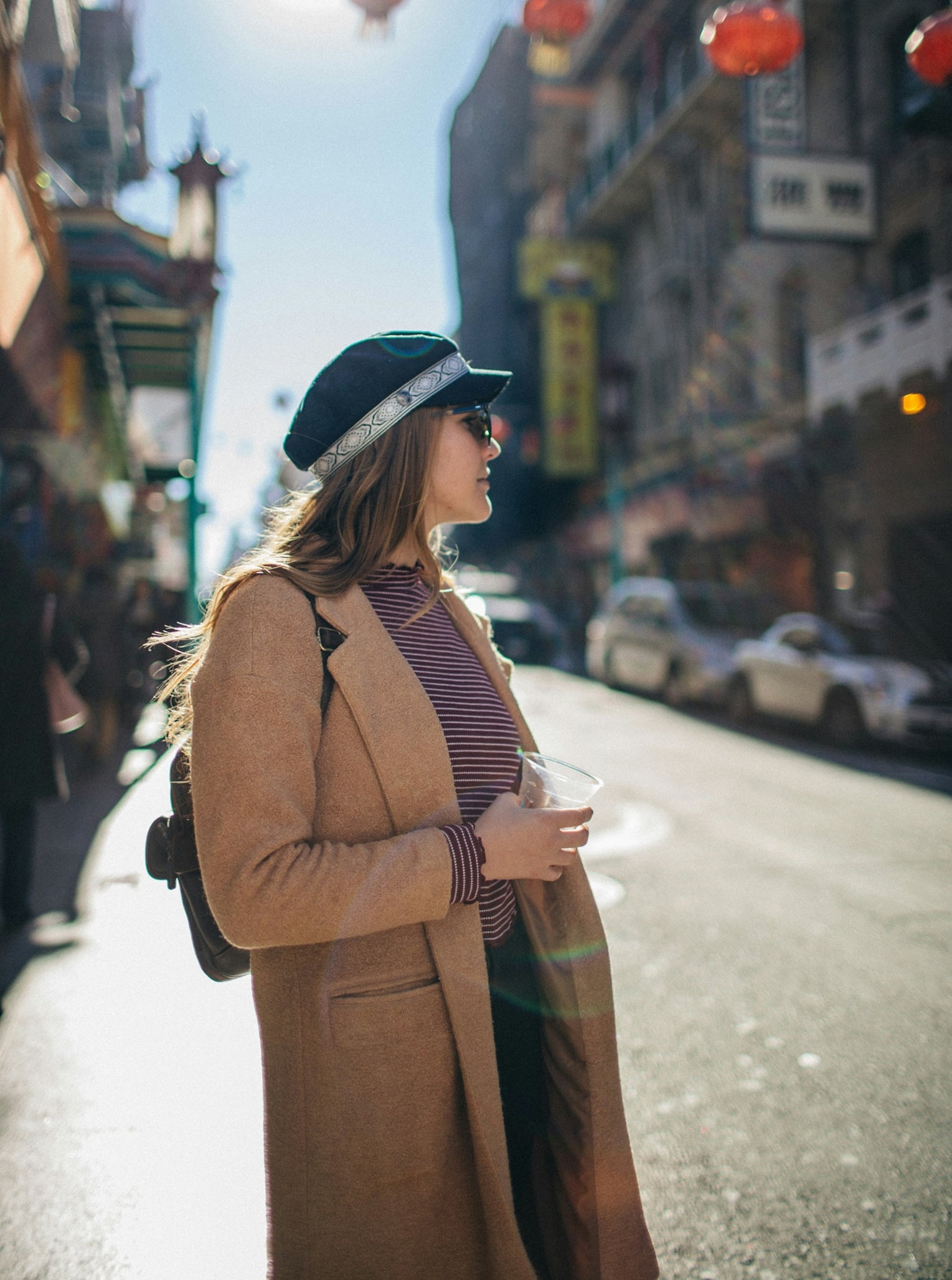 Woman in a brown coat styled for autumn street fashion