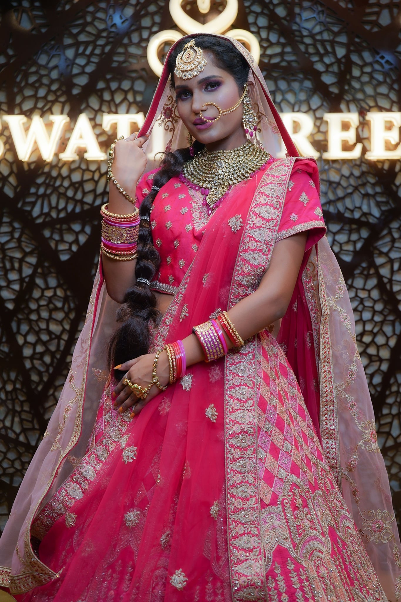 Woman wearing a pink saree and traditional jewellery