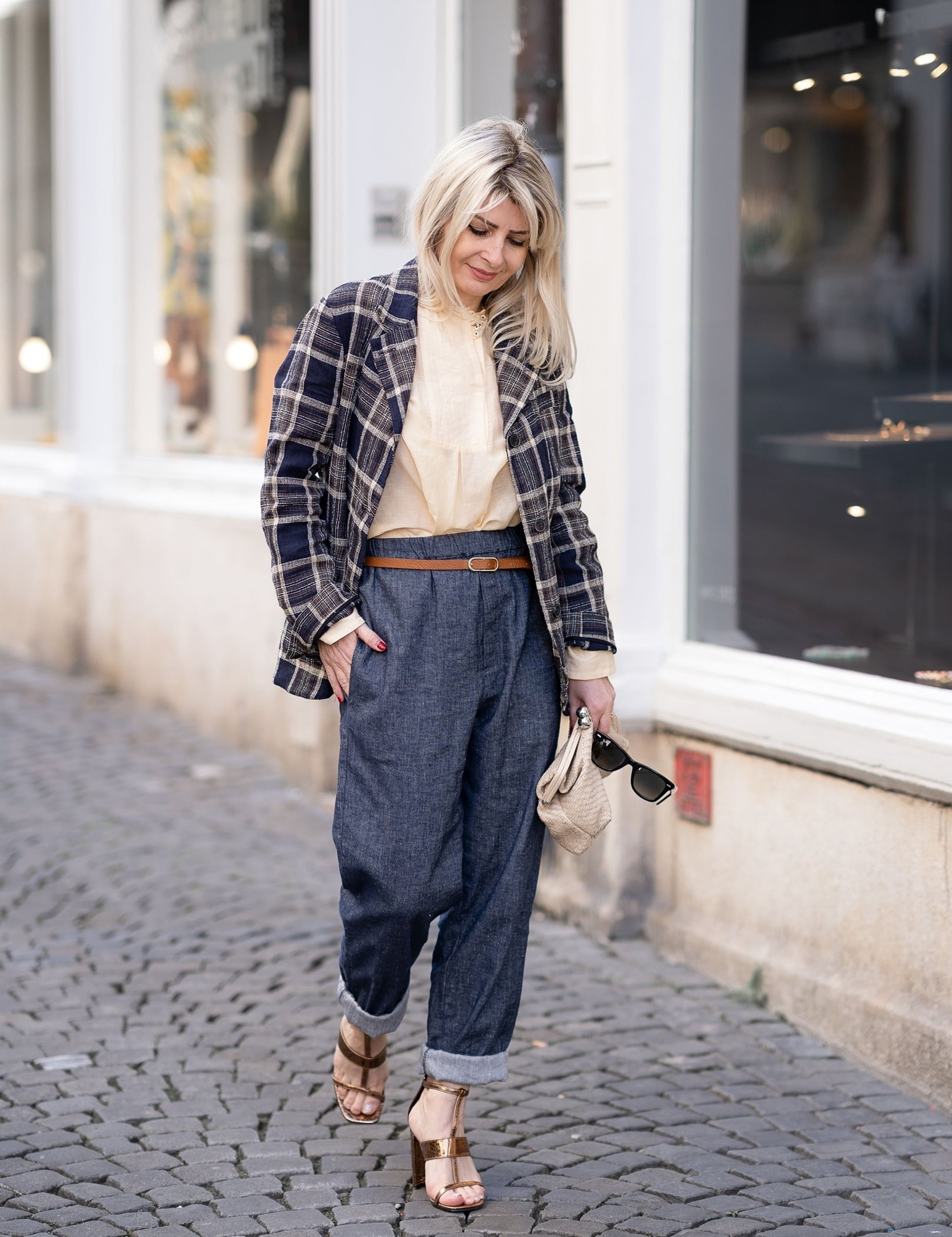 Woman wearing a plaid blazer with denim