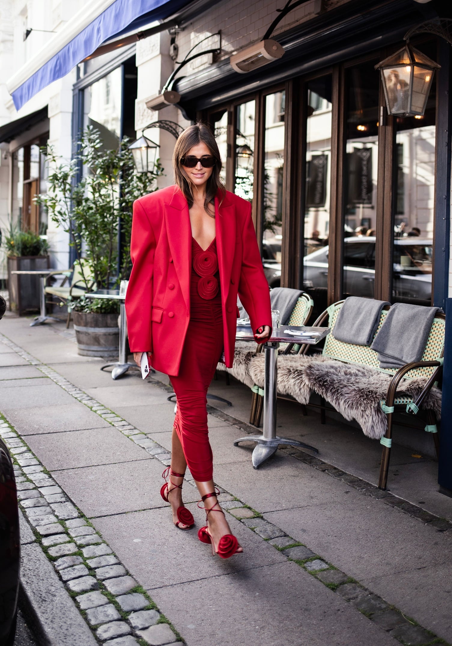 Woman wearing a red suit on a city street