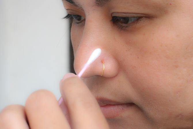 apply makeup around a nose piercing