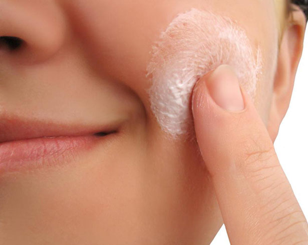 Applying cream to face