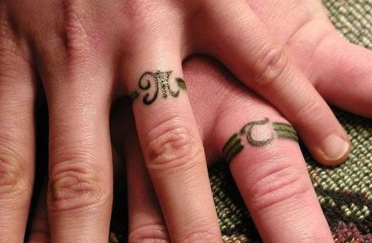 Minimalist initial tattooed on the finger