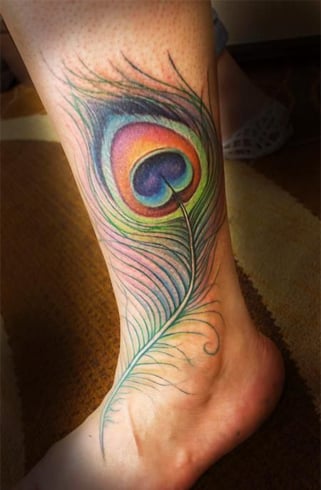 peacock feather tattoo on thigh