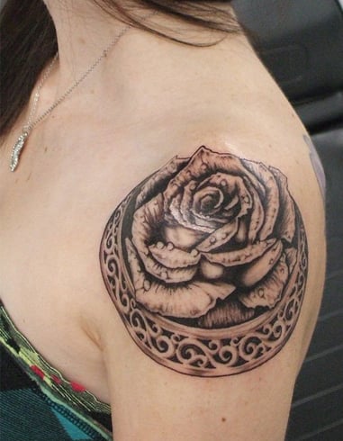 Rose tattoo on the left shoulder