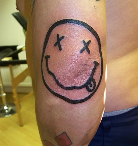 18 Cheerful Smiley Face Tattoo Designs  Moms Got the Stuff