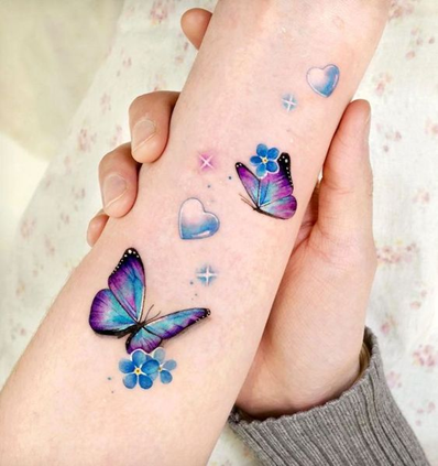 Tiny butterfly couple tattoo located on the hand