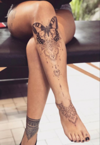 Intricate Butterfly Thigh Tattoo Design