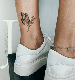 Butterfly on flower leg tattoo